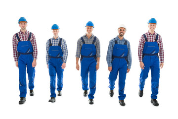 Portrait Of Confident Male Carpenters Walking In Row