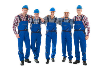 Confident Male Carpenters Standing With Arms Around