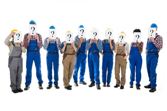 Construction Workers Hiding Faces With Question Mark Signs