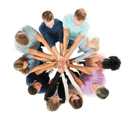Creative Business People Stacking Hands In Huddle
