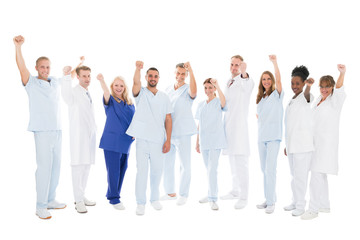 Multiethnic Medical Team Standing With Arms Raised