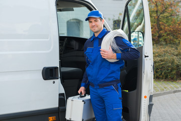 Confident Technician With Cable Coil And Toolbox