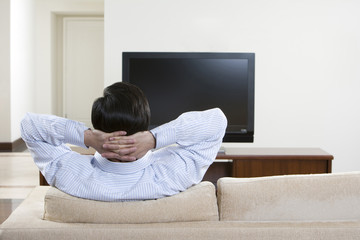 Man watching widescreen television