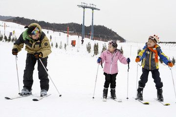 Father And Children Skiing
