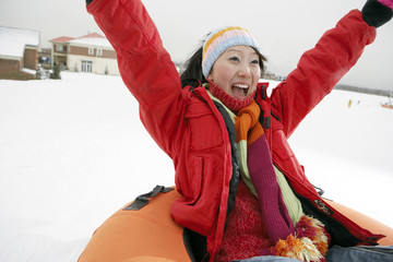 Mother Riding On Inflatable Snow Tube