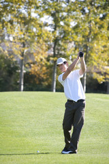 Young Man Taking Practice Golf Swing