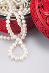 Close-Up of traditional Chinese longevity box with pearl necklace