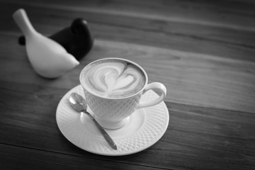 Hot art Latte Coffee in a cup on wooden table.
