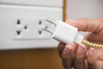 battery charger in woman hand