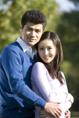 Obraz premium Portrait of a young couple in the park