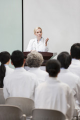 Female doctor giving speech in boardroom
