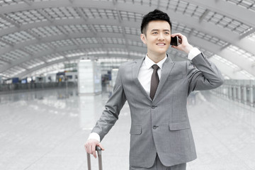 Young businessman on the phone at the airport