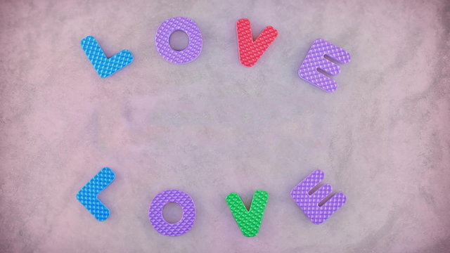 Word Love appearing three times on the pink texture for background. Different color letters and pink background become red in the end on the clip.