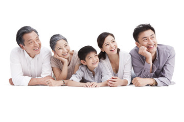 Happy family lying down on ground, looking at view