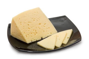 Cheese on the black plate isolated on white background