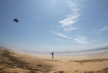 flying a kite on beach in Brittany, France