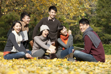 Excited college students on campus in a beautiful autumn day