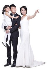 Happy family pointing forward