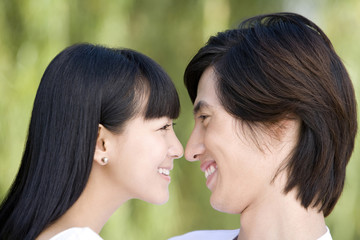 Close-up of young couple smiling to each other