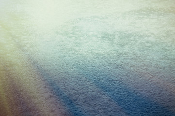The surface of the water in the rain background. Tinted image.