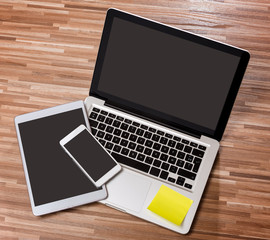 Laptop in high definition with tablet and mobile phone on a wood