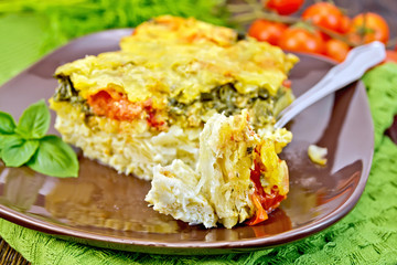 Pie potato with tomato and fork on board