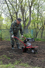 Man working in the garden preparing ground cultivator