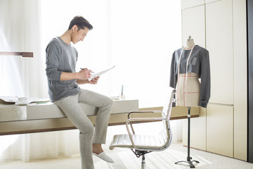 Fashion designer looking at sketch
