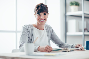 Smiling woman reading a book