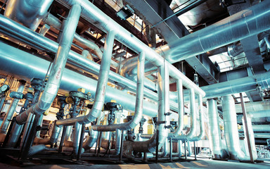 Equipment, cables and piping as found inside of a modern industr