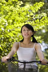 Obraz premium A young woman rides her bike