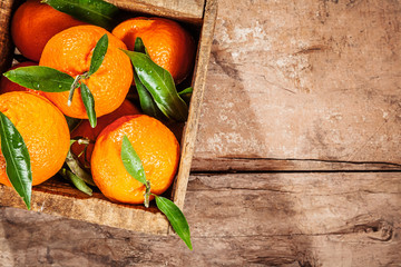 Wooden crate of fresh colorful clementines