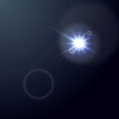 Shiny light lens flare on dark blue background
