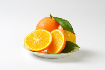 Fresh ripe oranges with leaves