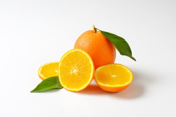 Fresh ripe oranges with leaves
