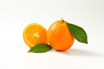 Fresh ripe oranges with leaves