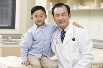 Doctor and Young Boy In Examination Room
