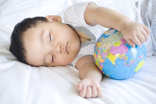 Infant sleeping with globe