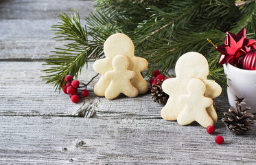 Christmas homemade gingerbread couple and tree on wooden table