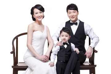 Happy young family sitting in chairs