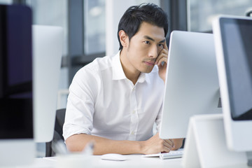 Young businessman using computer in office