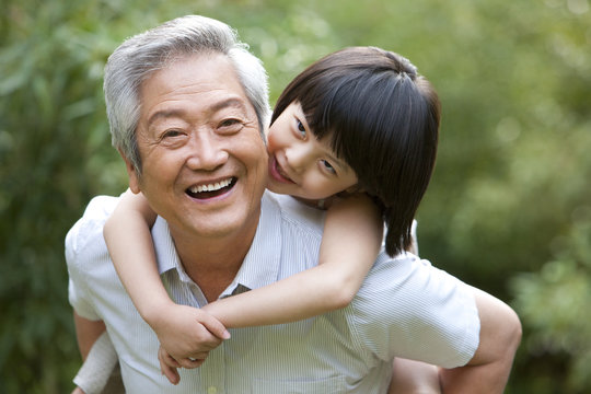 Grandpa and grandaughter having fun in garden
