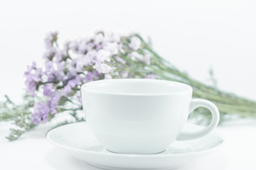 Obraz na płótnie Canvas White mug cup and static flower