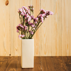 statice flower bouquet on wood background