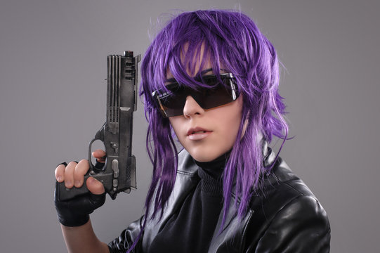 Woman with gun / Portrait of sexy woman posing in studio with gun