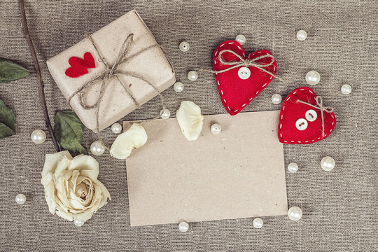 paper card with gift box, white rose, heart and pearls beads