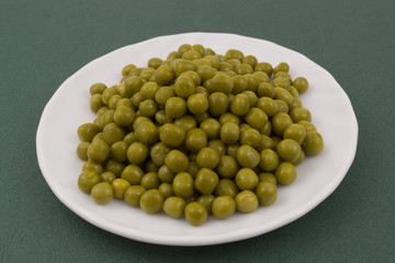 Green peas on a white plate
