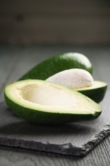 ripe avocados on slate board
