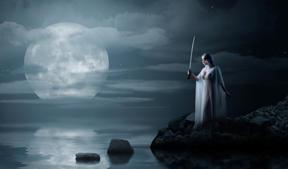 Elven girl with sword on night sea coast