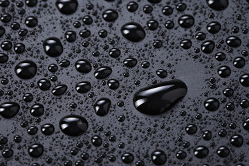 water drops on a black plastic surface